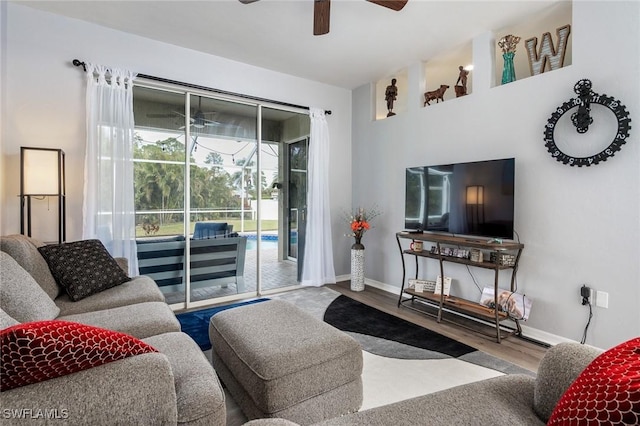 living room with ceiling fan and hardwood / wood-style floors