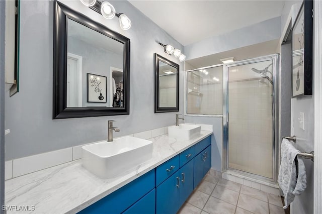 bathroom featuring an enclosed shower, vanity, and tile patterned flooring