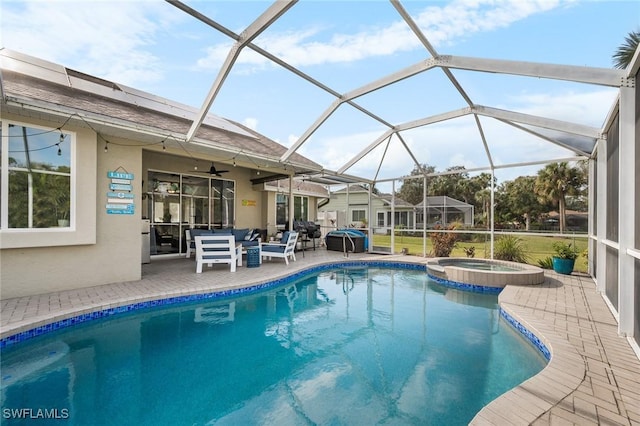 view of pool featuring a lanai, an in ground hot tub, and a patio