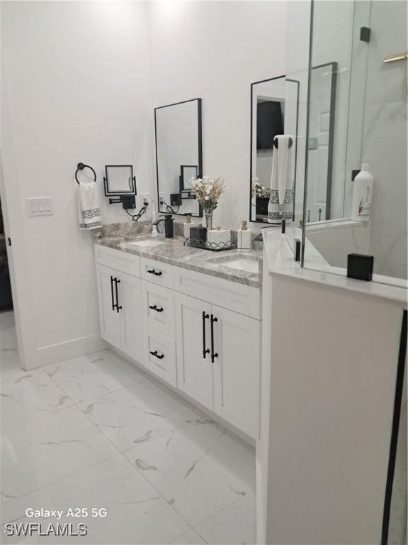 bathroom featuring an enclosed shower and vanity