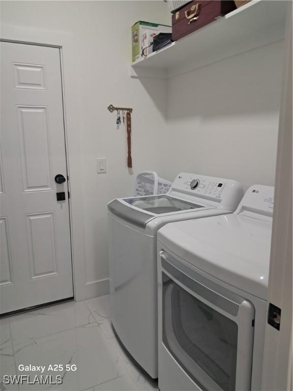 clothes washing area featuring separate washer and dryer