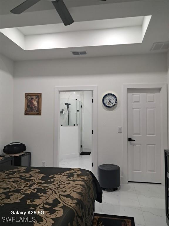 bedroom with ceiling fan and a raised ceiling