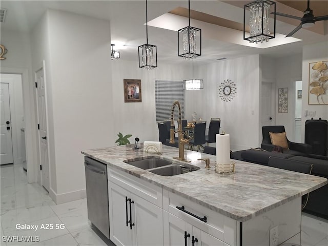 kitchen featuring pendant lighting, dishwasher, white cabinetry, sink, and a kitchen island with sink