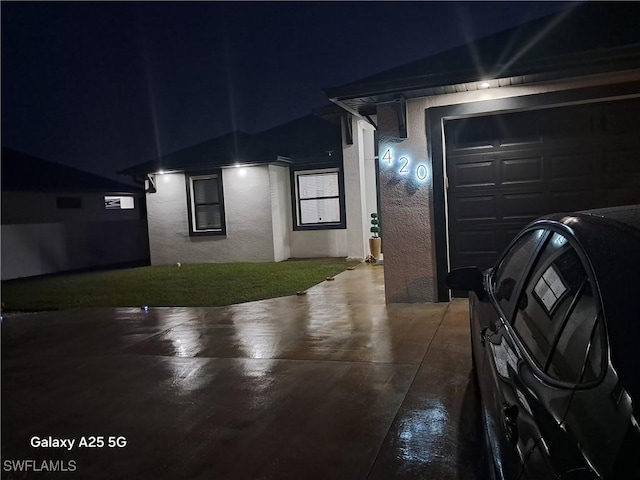 view of garage at twilight