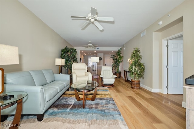 living room with ceiling fan and wood-type flooring