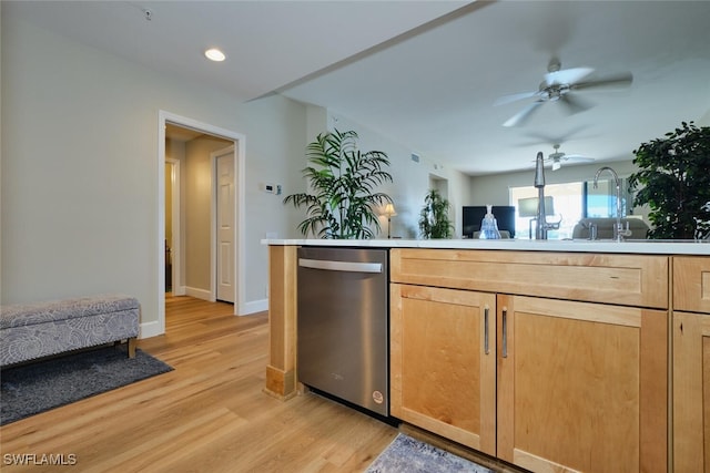 kitchen featuring stainless steel dishwasher, ceiling fan, sink, and light hardwood / wood-style floors