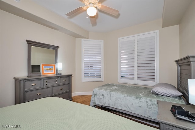 bedroom with ceiling fan and light hardwood / wood-style floors