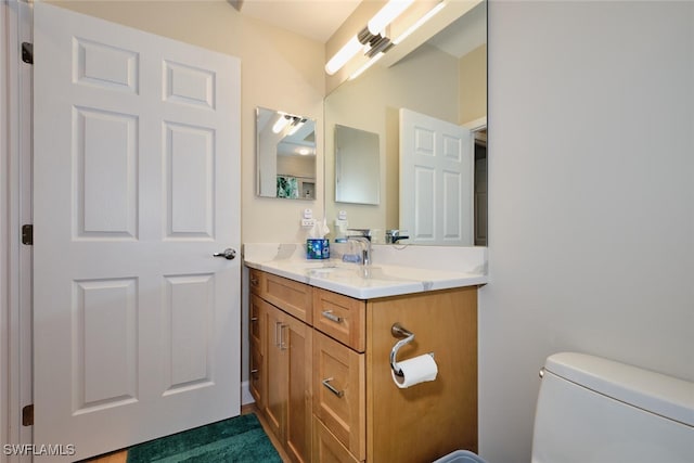 bathroom with toilet and vanity