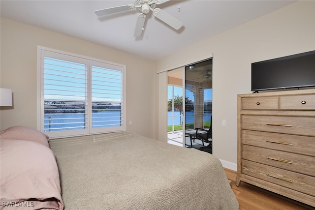 bedroom featuring ceiling fan, a closet, light hardwood / wood-style flooring, and access to outside