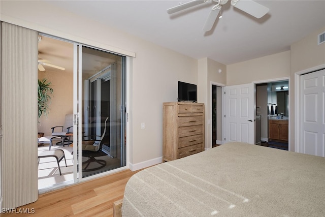 bedroom featuring ceiling fan, access to exterior, hardwood / wood-style flooring, and ensuite bath