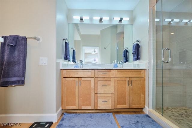 bathroom featuring an enclosed shower, vanity, and hardwood / wood-style floors