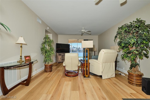 living room with ceiling fan and light hardwood / wood-style floors