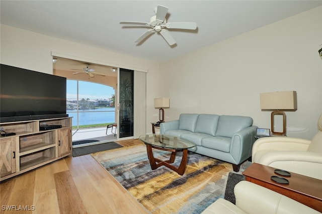 living room with hardwood / wood-style flooring and ceiling fan