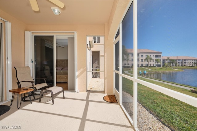 sunroom / solarium featuring a water view