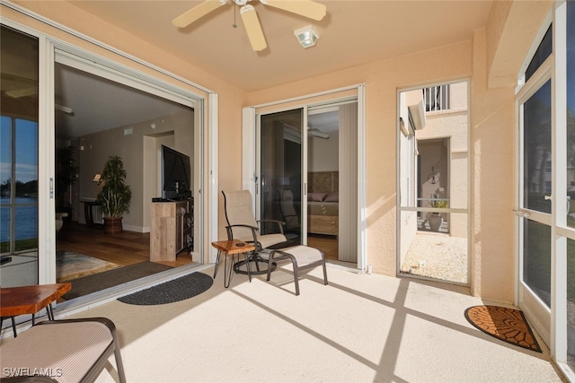 sunroom / solarium featuring ceiling fan