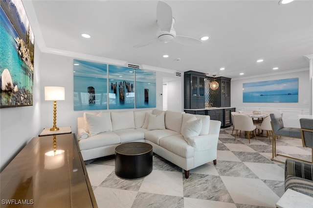 living room featuring ceiling fan, beverage cooler, and crown molding