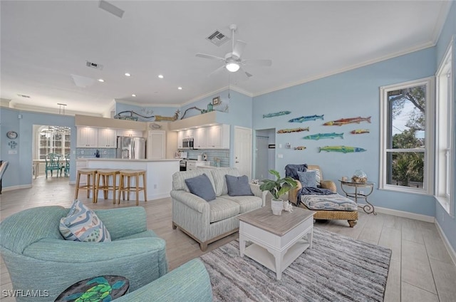 living room with crown molding, ceiling fan, and light hardwood / wood-style flooring