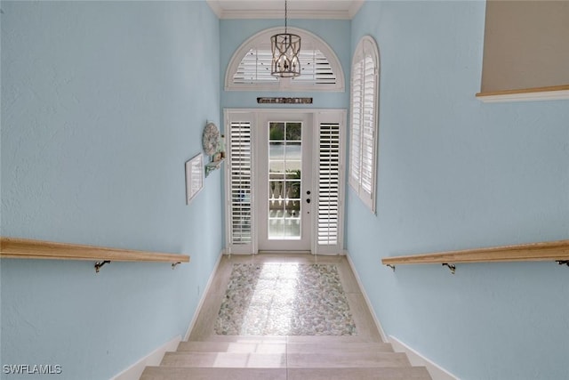 tiled foyer entrance featuring a chandelier