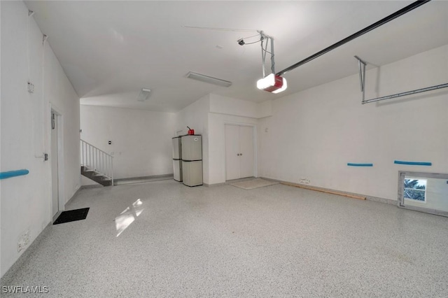 garage featuring a garage door opener and refrigerator