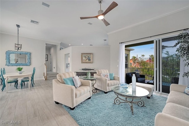 living room with ornamental molding and ceiling fan