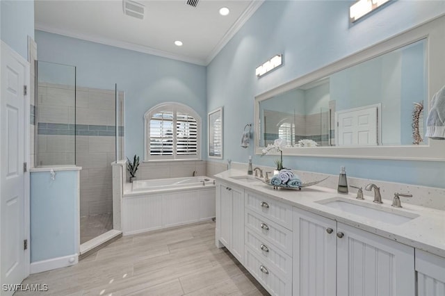 bathroom with ornamental molding, shower with separate bathtub, and vanity