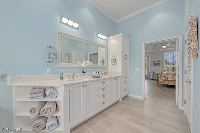 bathroom with hardwood / wood-style flooring, ornamental molding, vanity, and ceiling fan