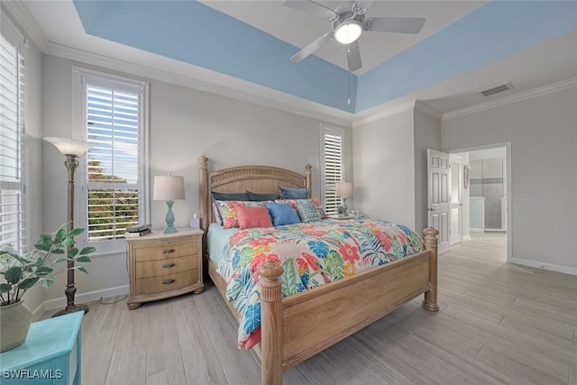 bedroom with a raised ceiling, crown molding, ceiling fan, and light hardwood / wood-style flooring