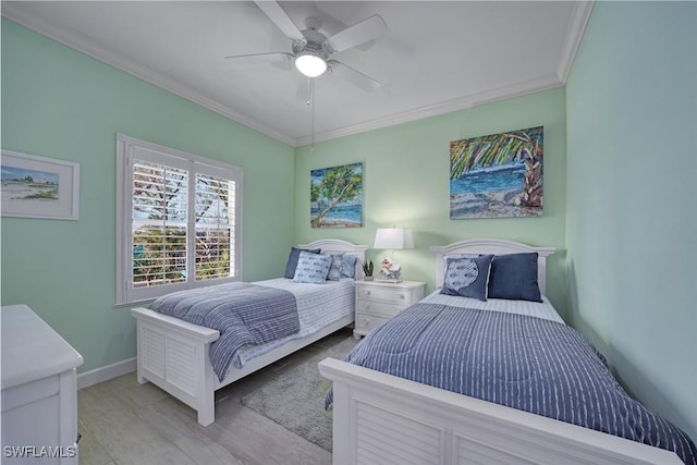 bedroom with crown molding, light hardwood / wood-style floors, and ceiling fan