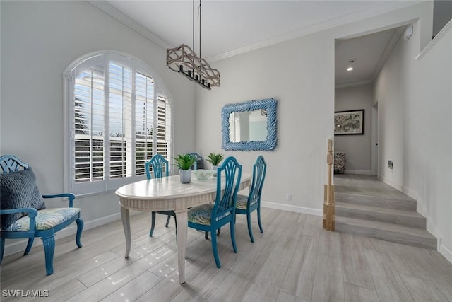 dining room featuring ornamental molding and light wood-type flooring