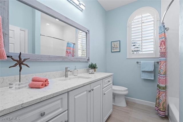 full bathroom featuring vanity, shower / bath combination with curtain, and toilet