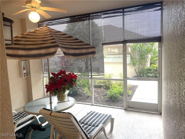 sunroom featuring ceiling fan