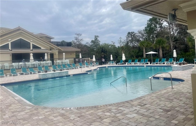 pool featuring a patio area and fence