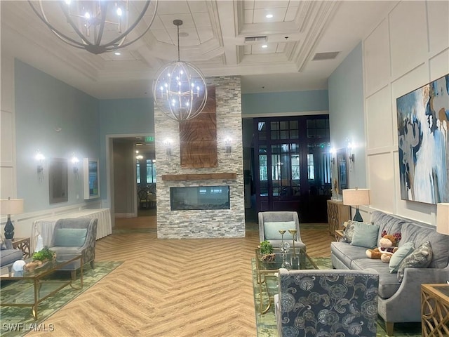 living room featuring a towering ceiling, visible vents, coffered ceiling, and a stone fireplace