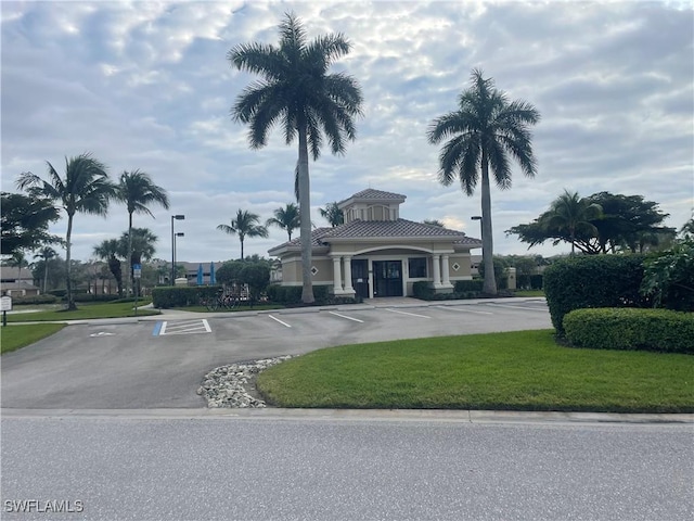 view of building exterior with uncovered parking