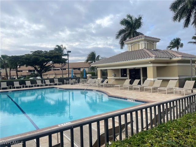 pool featuring a patio and fence