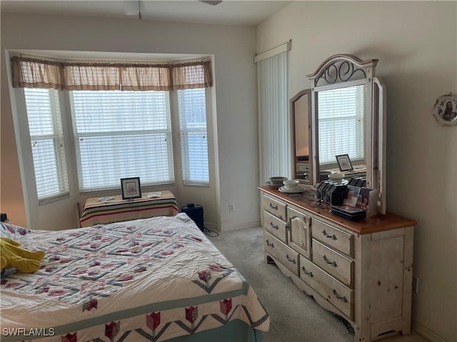 bedroom featuring baseboards and light colored carpet