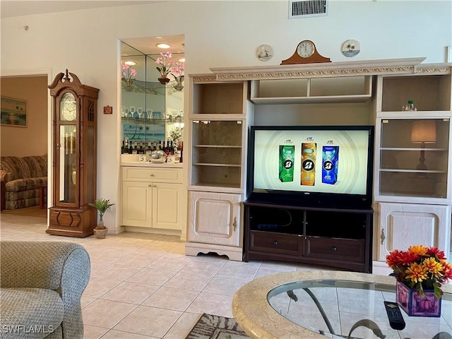 living room featuring light tile patterned floors and visible vents