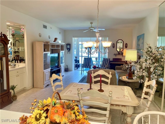 dining space featuring a chandelier, light tile patterned flooring, and visible vents