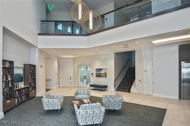8580 Cedar Hammock Cir Unit 714, Naples, FL 34112 - tiled living area with a towering ceiling, stairway, recessed lighting, and elevator