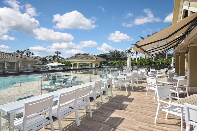 8580 Cedar Hammock Cir Unit 714, Naples, FL 34112 - wooden terrace with a gazebo and outdoor dining area
