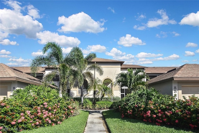 8580 Cedar Hammock Cir Unit 714, Naples, FL 34112 - view of front of home with stucco siding, an attached garage, and roof with shingles