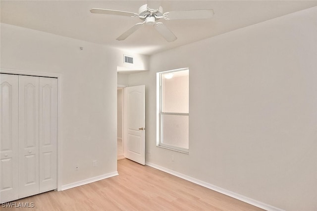 8580 Cedar Hammock Cir Unit 714, Naples, FL 34112 - unfurnished bedroom with light wood-type flooring, a closet, and a ceiling fan