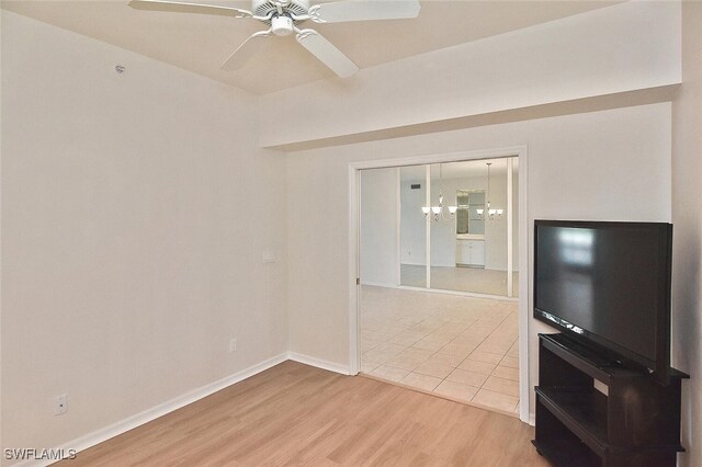 8580 Cedar Hammock Cir Unit 714, Naples, FL 34112 - unfurnished living room featuring light wood-style floors, a chandelier, and a ceiling fan