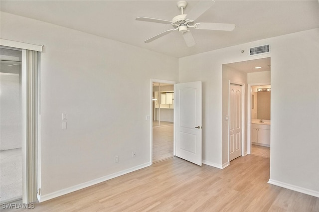 8580 Cedar Hammock Cir Unit 714, Naples, FL 34112 - unfurnished bedroom with light wood-type flooring, ceiling fan, and ensuite bath