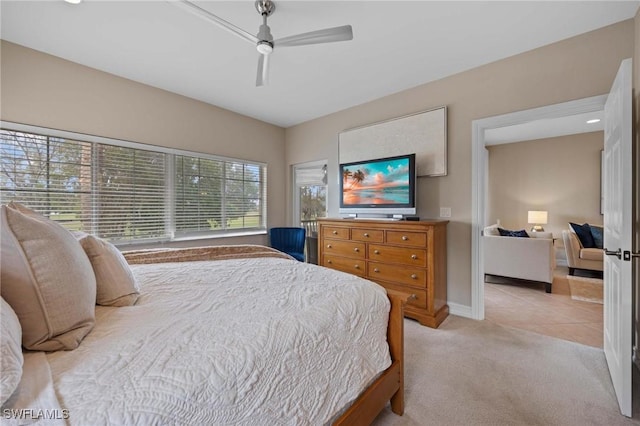 bedroom featuring ceiling fan and light carpet