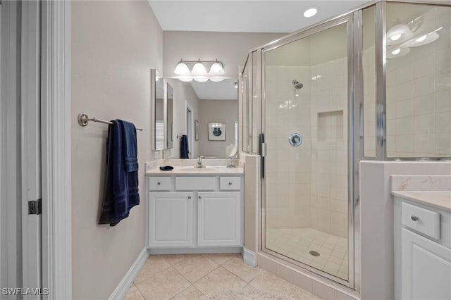 bathroom featuring walk in shower, vanity, and tile patterned flooring