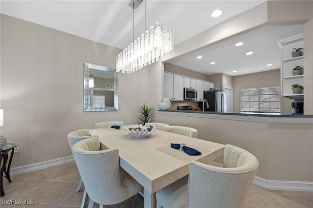 tiled dining space with an inviting chandelier