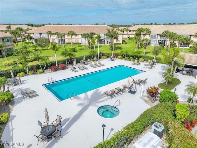 view of swimming pool featuring a patio area and a community hot tub