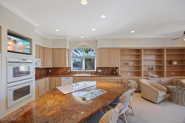 kitchen with sink, light brown cabinets, white appliances, dark stone counters, and backsplash