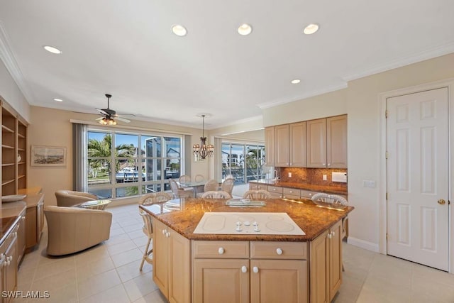 kitchen with hanging light fixtures, crown molding, a center island, and a kitchen bar